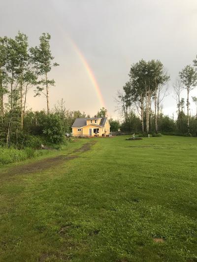 rainbow over rural dawson creek home